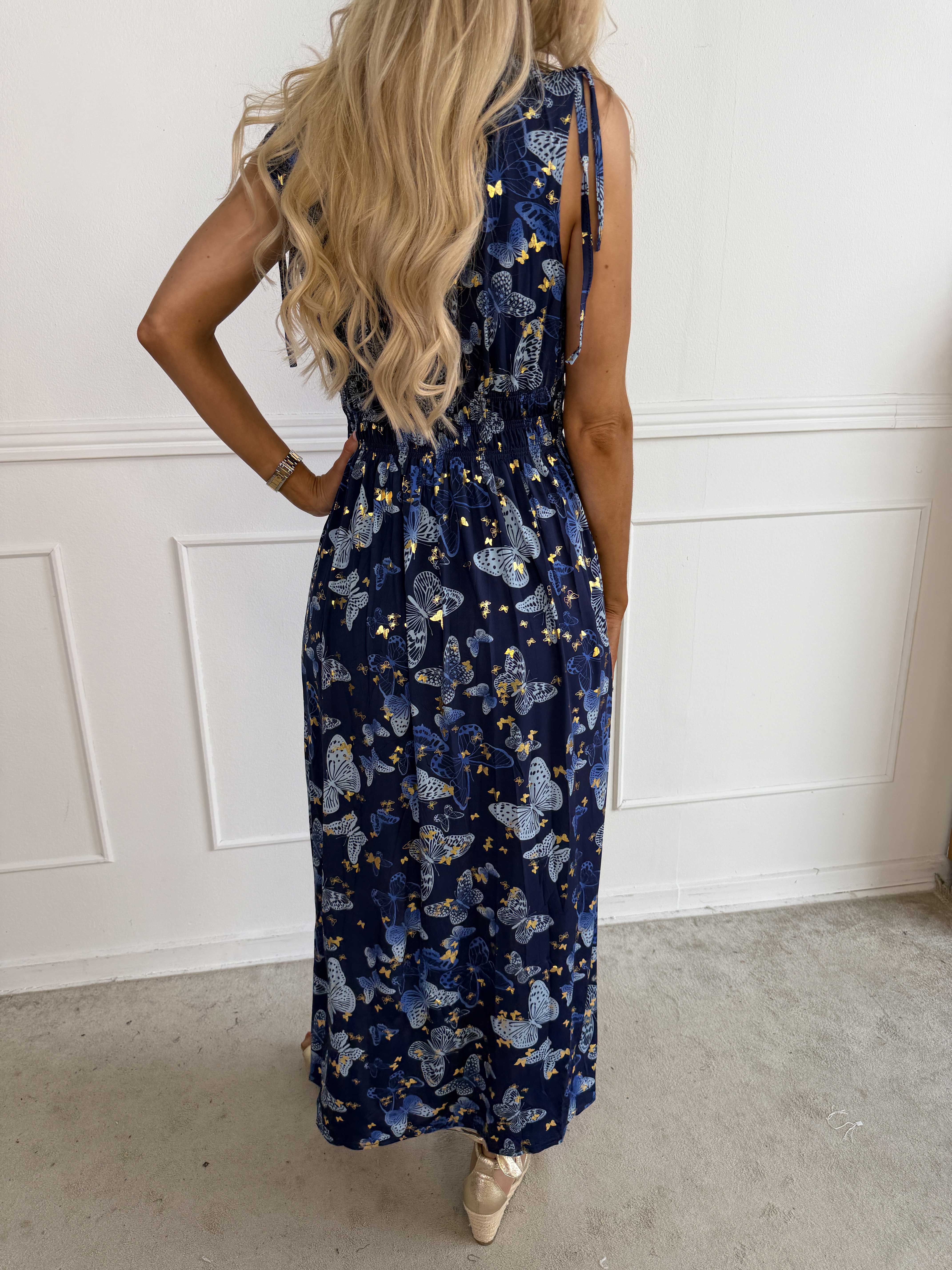 Pams Butterfly Sleeveless - A long, stretchy dress with a butterfly print and gold details
